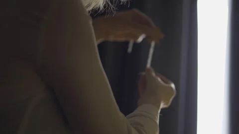 Hands Adjusting Curtain Cord by Bright Window Stock Footage 329118566