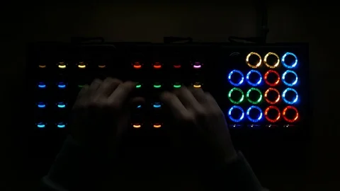 Hands adjusting knobs and pressing buttons on a captivating futuristic Stock Footage 102087162