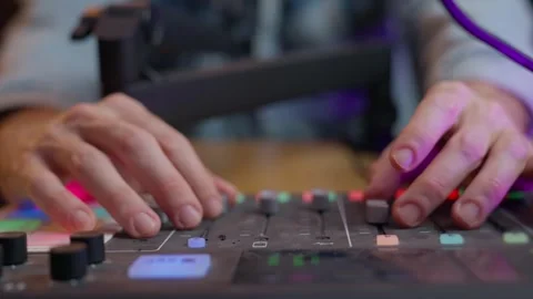Hands adjusting knobs and sliders on a podcast or sound engineering control Video stock 305675391