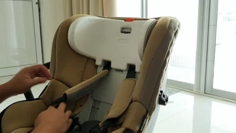 Hands Adjusting Padding on Car Seat Near Large Window Video stock 337451191