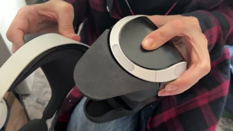 Hands adjusting VR headset position close up, virtual reality device setup and Stock Footage 337119959