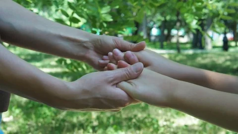 The hands of an adult and the hands of a child. Stock Footage
