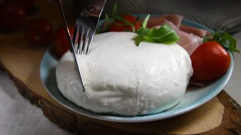The hands aer putting one slice of mozzarella cheese Stock Footage 131556750