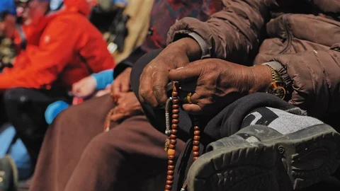 Hands of aged nepali man hold prayer mala, counting beads at meditation, Nepal Video stock 124678022