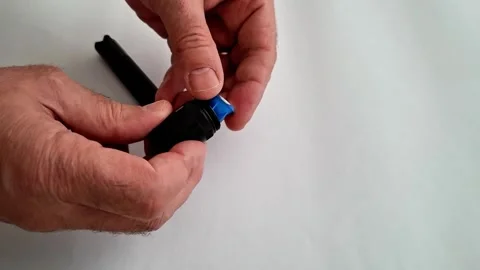 Hands Aligning Blue and Silver Piece with Black Flashlight Component 動画素材 332890593