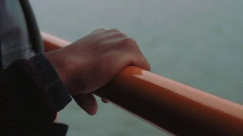 Hands along the railing of the Staten Island Ferry Stock Footage 76540461