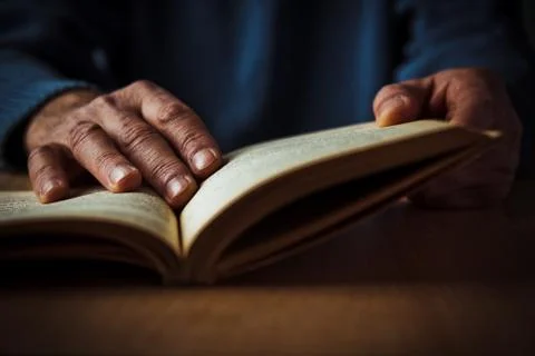 Hands and book Stock Photos