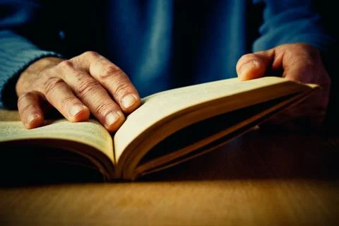 Hands and book Stock Photos
