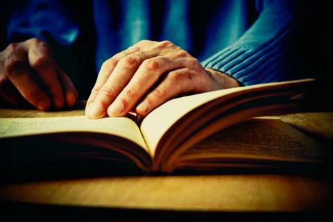 Hands and book Stock Photos