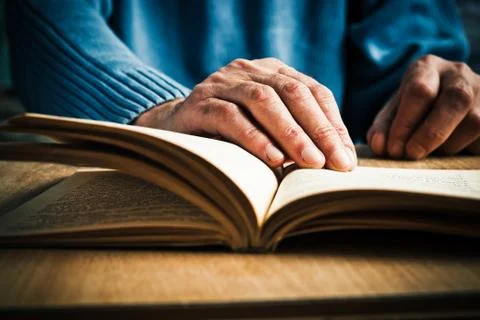 Hands and book Stock Photos