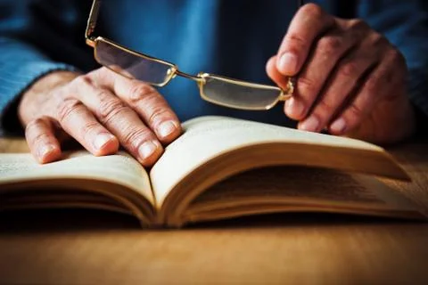 Hands and book Stock Photos