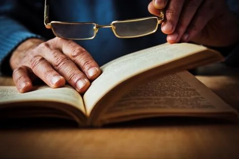 Hands and book Stock Photos