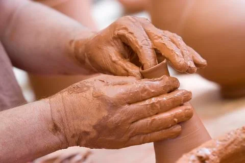 Hands and clay. Stock Photos