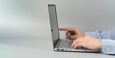 Hands and computer laptop or notebook on grey background.Studio shot.top eye  Stock Photos