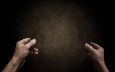 Hands and the dark background Stock Photos
