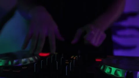 Hands and DJ console at work. DJ playing at a party, close-up. Stock Photos