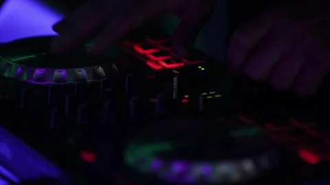 Hands and DJ console at work. DJ playing at a party, close-up. Stock Photos