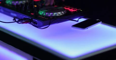 Hands and DJ console at work. DJ playing at a party, close-up. Stock Photos