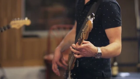 Hands and Face of a Man Playing an Electric Guitar Stock Footage 72224534