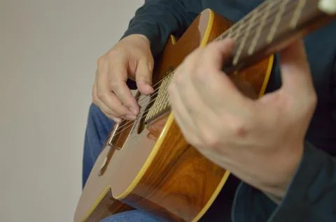 Hands and guitar - a man plays an instrument in a recording Studio Stock Photos