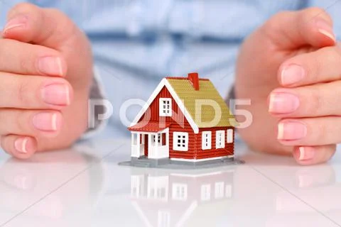 Hands and house. Stock Photos