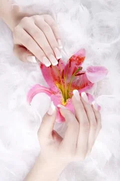 Hands and nails with feathers Stock Photos