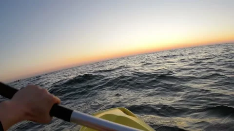 Hands and paddle during kayaking in the sea at sunrise - POV, Dutch angle, Wide Stock Footage 158021979