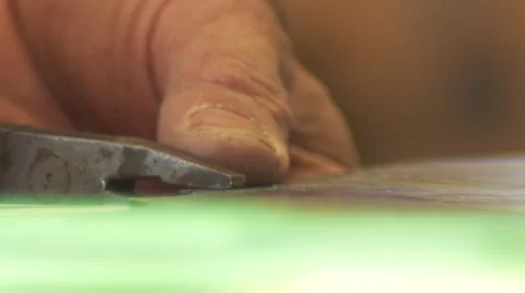 Hands and pliers snapping a stained glass piece Stock Footage 33063518