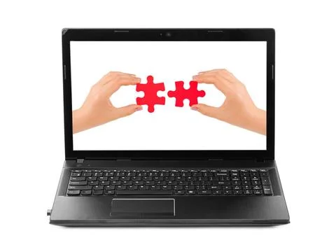 Hands and puzzle in computer notebook Hands and puzzle in computer - isola... Foto stock