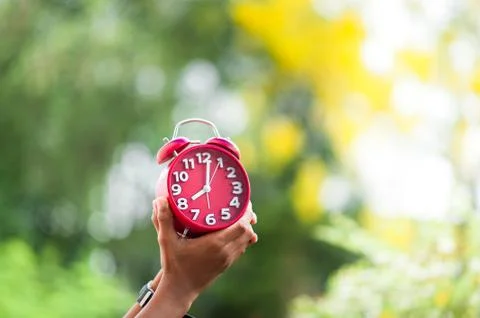 Hands and red clocks Фото