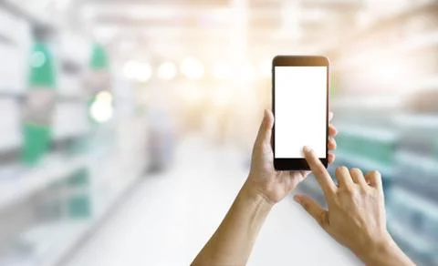 Hands and using mobile smart phone in supermarket shop for shopping online Fotos de archivo