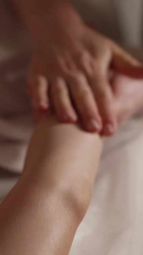 Hands apply massage on a person's arm in a quiet room at a spa Stock Footage 341280978
