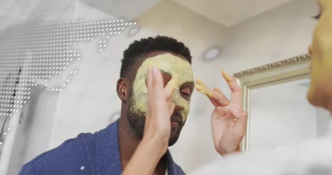 Hands applying clay mask across upper face at mirror launching map-code overlay Stock Footage 318012812