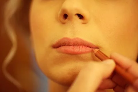 Hands applying lipstick Stock Photos