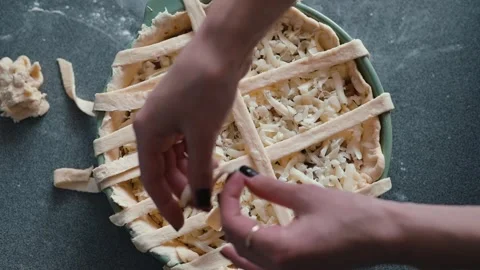 A hands-on approach to creating a pie with a lattice crust is shown in each Stock Footage 339094651