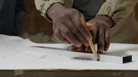 Hands of Architect Drawing on Draft of Blueprint in Unfinished Apartment Stock Footage 308912841