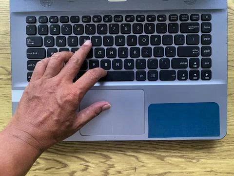 Hands are actively typing on a computer or laptop keyboard, daily work activity Stock Photos