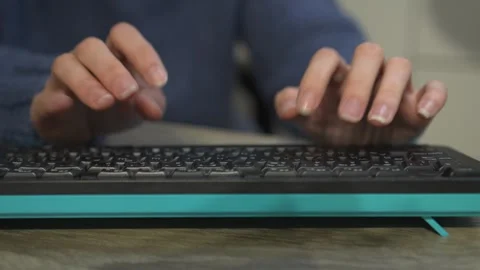 Hands are actively typing on a keyboard in a modern and dynamic workspace Stock Footage 318544188