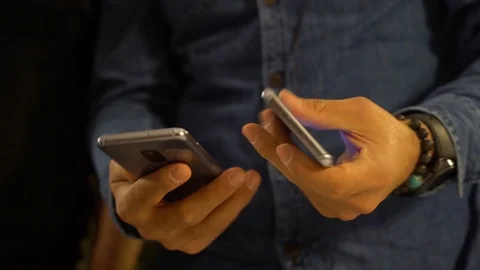 Hands are comparing mobile phones Stock Footage 115024586