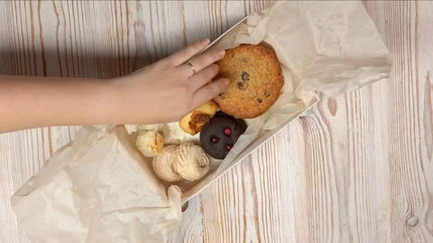 Hands are disassemble biscuits in the box Stock Footage 257307293