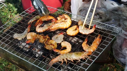 The hands are grilled Seafood grill or  barbecue with charcoal in the party. 動画素材 70153306