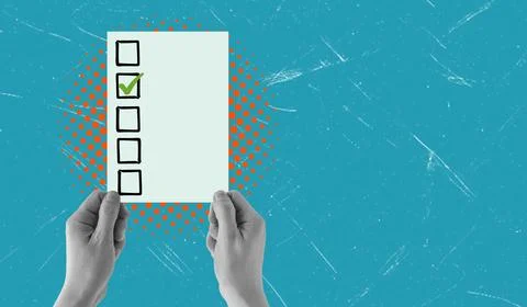 Hands are holding a paper with checkboxes on it. One box is checked, showing  Stock Photos