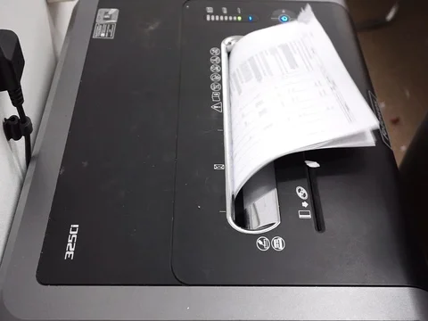 Hands are inserting office documents for disposal into shredder machines Stock Footage 86716801