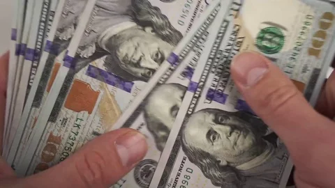Hands are inspecting 100 Dollar Bills Close-up Stock Footage 73831351