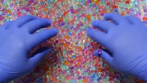 The hands are moving in a lot of colored,shiny orbis. View from above, Part13.14 Stock Footage 277455034