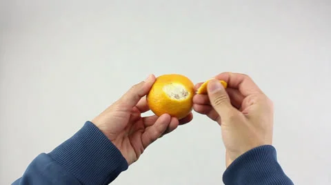 Hands are peeling a tangerine Video stock 25877199