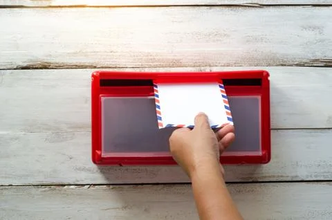 Hands are picking up the envelope in the mailbox. Stock Photos