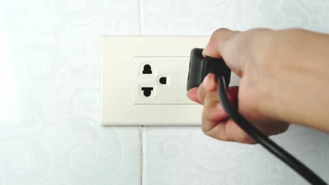 Hands are plugging in. in his office during working hours energy saving concept  스톡 동영상 169165269