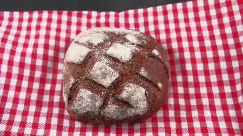 Hands are putting the whole fresh-baked bread or loaf Stock Footage 158096147