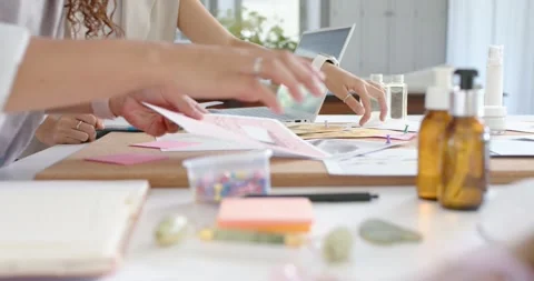 Hands are reaching for papers as project is starting on table, arranging sticky Stock Footage 336897714